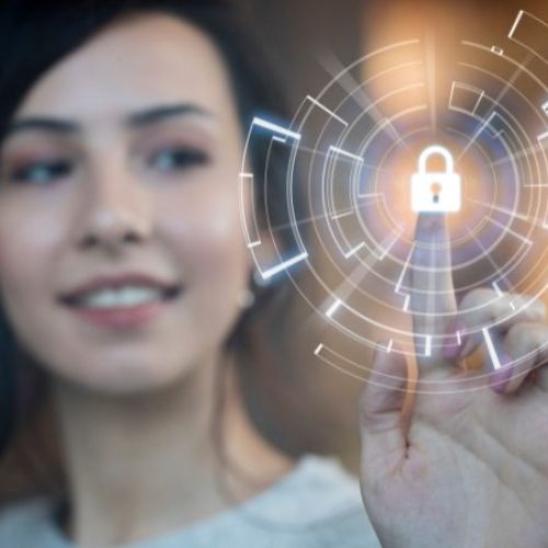 An out of focus photo of a woman taping a screen that has a lock icon on it.